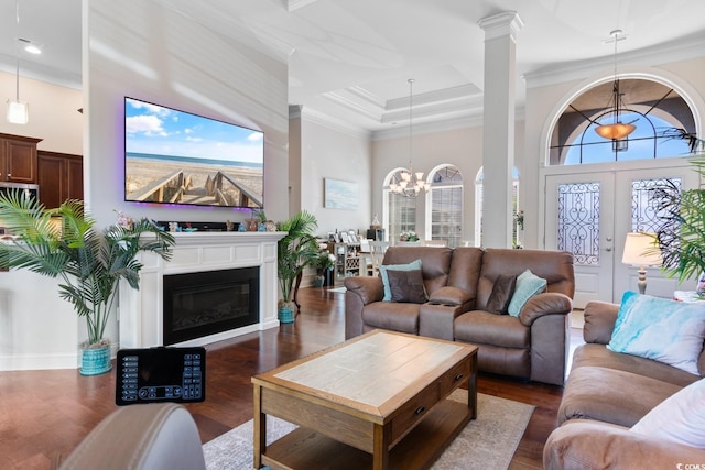 9060 Abingdon Dr, Myrtle Beach, SC 29579 - living room featuring an inviting chandelier, ornamental molding, dark wood-style flooring, a glass covered fireplace, and recessed lighting