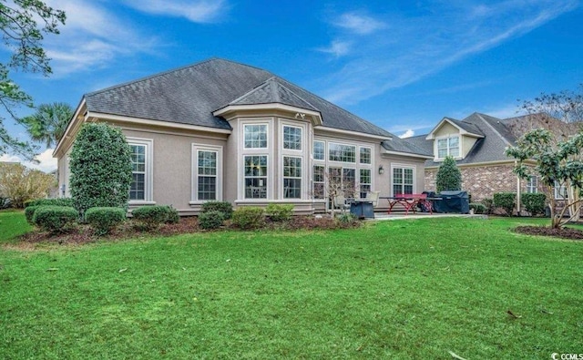 9060 Abingdon Dr, Myrtle Beach, SC 29579 - back of property featuring a yard, a shingled roof, and stucco siding