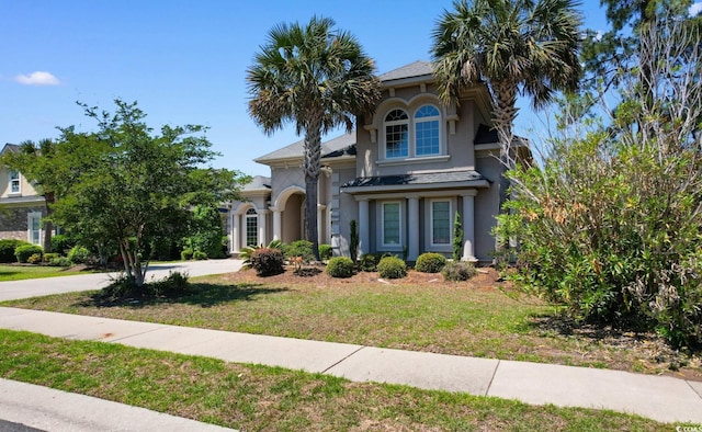 9060 Abingdon Dr, Myrtle Beach, SC 29579 - view of front of home featuring stucco siding, concrete driveway, and a front yard