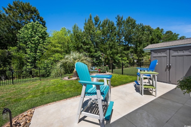 view of patio / terrace featuring a fenced backyard and an outbuilding