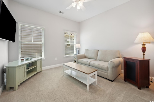 living room with a ceiling fan, light colored carpet, visible vents, and baseboards