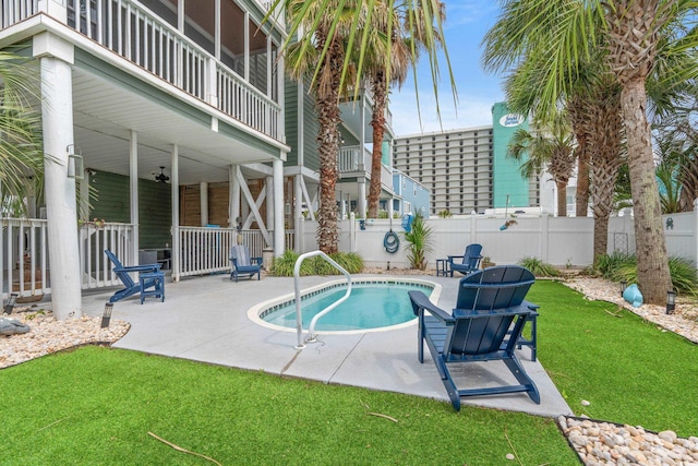 view of swimming pool featuring a fenced in pool, fence, a yard, and a patio