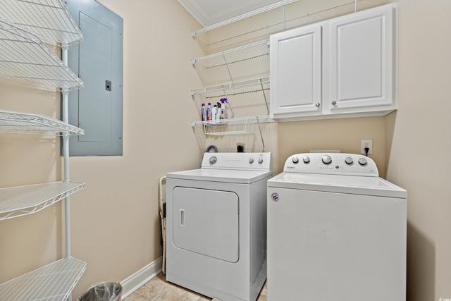 clothes washing area with baseboards, cabinet space, and washer and dryer