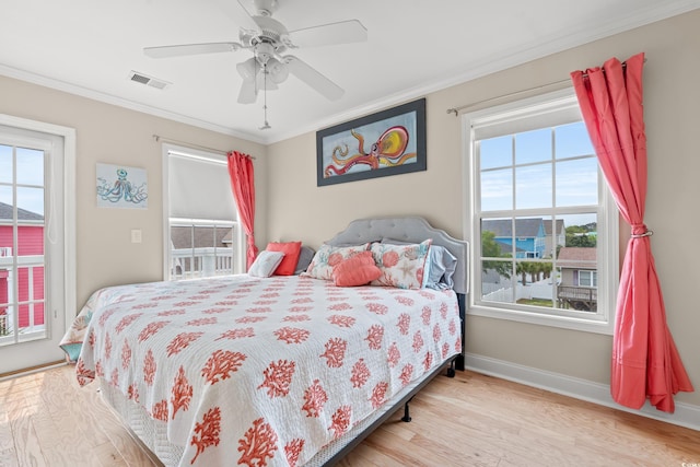 bedroom featuring visible vents, ornamental molding, baseboards, and access to exterior