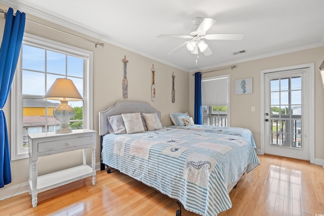 bedroom with access to outside, crown molding, wood finished floors, and visible vents