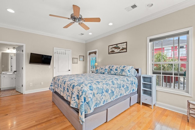 bedroom with crown molding, baseboards, light wood-type flooring, and visible vents