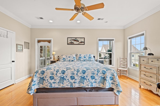 bedroom with crown molding, baseboards, light wood-type flooring, and visible vents