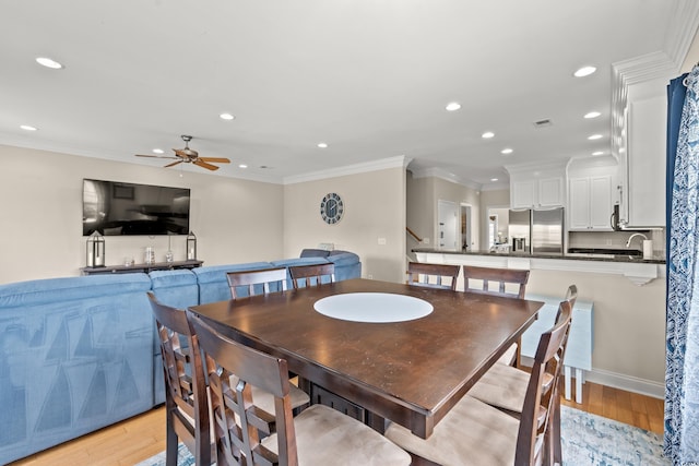 dining space with light wood-style floors, ceiling fan, recessed lighting, and crown molding