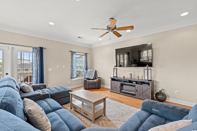 living room with ceiling fan, visible vents, wood finished floors, ornamental molding, and recessed lighting