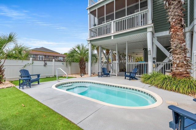 view of pool with a patio and fence