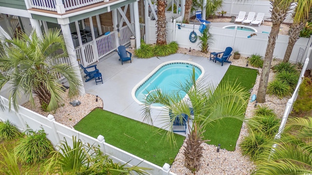 view of swimming pool featuring a fenced backyard and a patio area