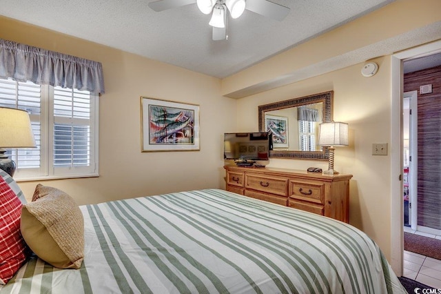 bedroom with tile patterned flooring and a ceiling fan
