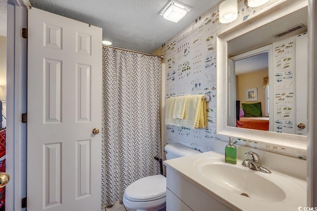 full bathroom featuring toilet, wallpapered walls, a textured ceiling, visible vents, and vanity
