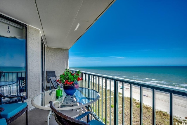 balcony with a view of the beach and a water view