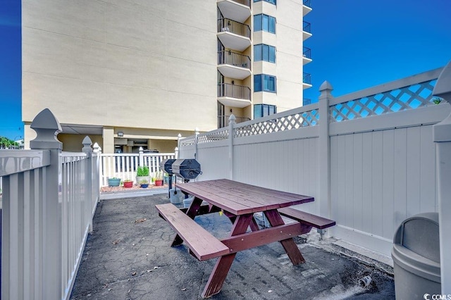 view of patio with outdoor dining space, area for grilling, and fence