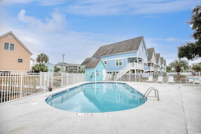 1023 S Sea Bridge Ct, Surfside Beach, SC 29575 - community pool with a patio area and stairway