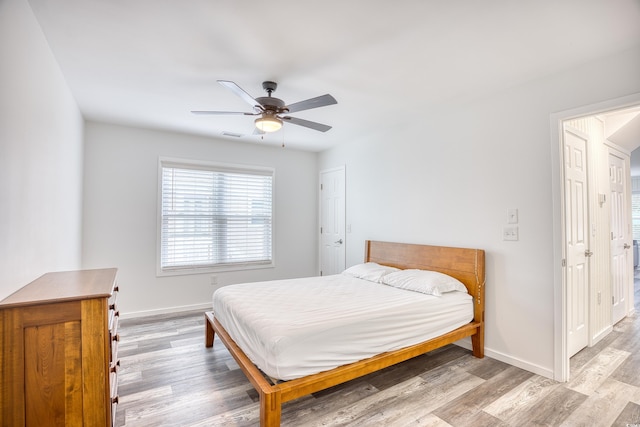 1023 S Sea Bridge Ct, Surfside Beach, SC 29575 - bedroom with light wood-style floors, baseboards, and ceiling fan