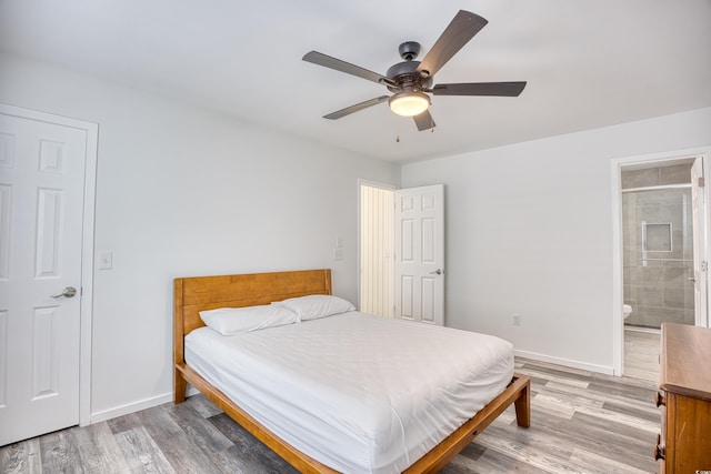 1023 S Sea Bridge Ct, Surfside Beach, SC 29575 - bedroom featuring light wood-type flooring, baseboards, ensuite bath, and ceiling fan
