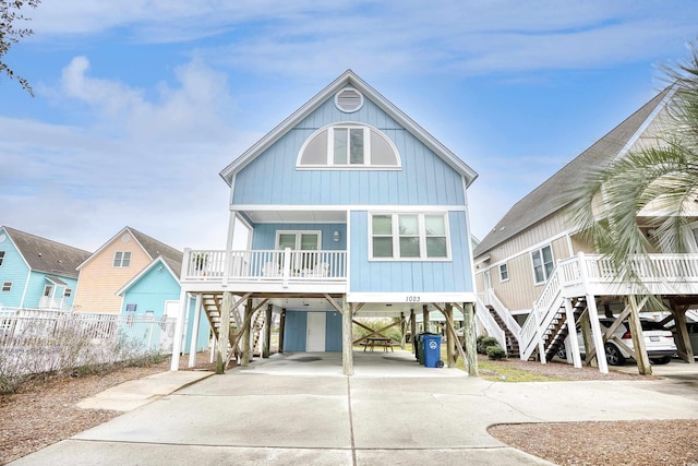 1023 S Sea Bridge Ct, Surfside Beach, SC 29575 - rear view of property with stairs, covered porch, a carport, and driveway