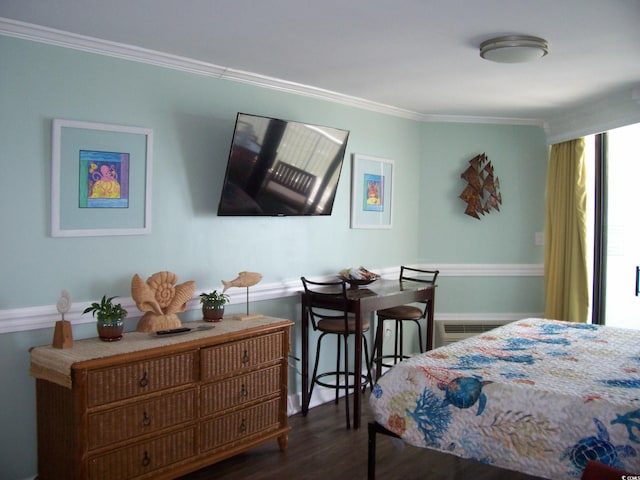 bedroom with baseboards, ornamental molding, and wood finished floors