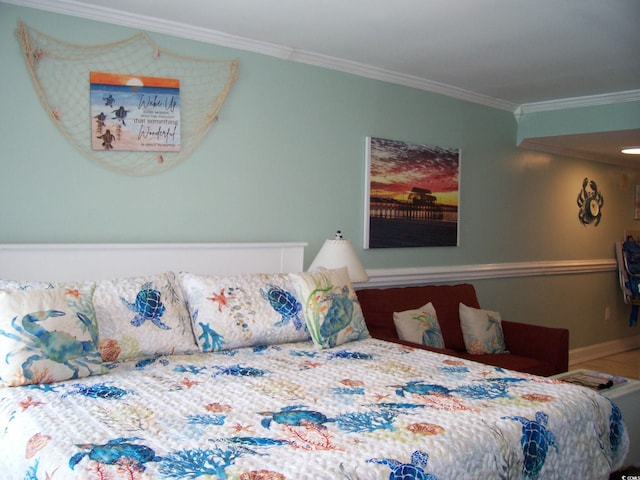bedroom featuring crown molding and baseboards