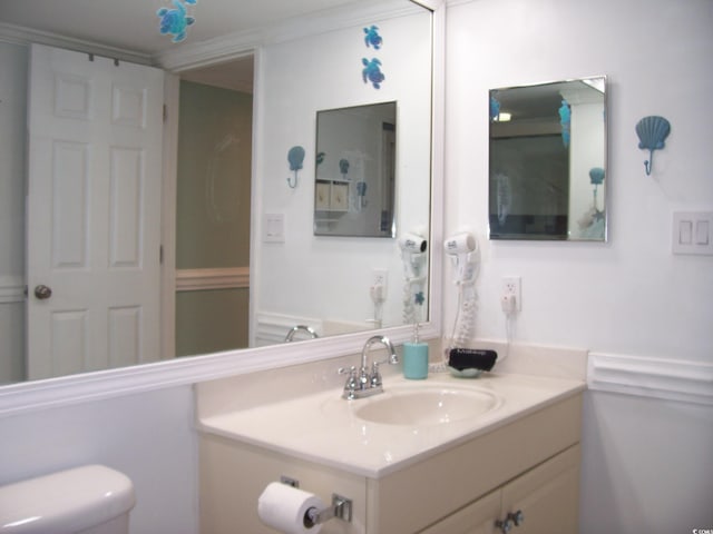 bathroom featuring toilet and vanity