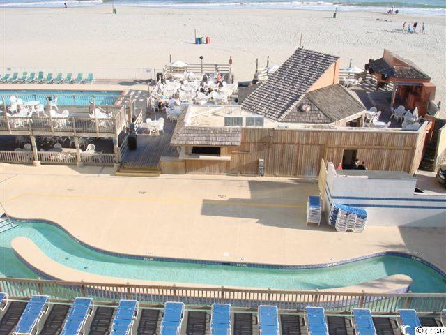 community pool with a beach view and a water view