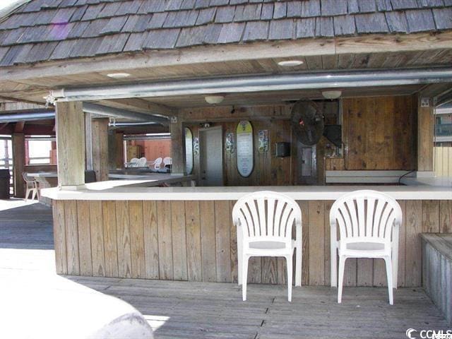 bar with wood walls and wood finished floors
