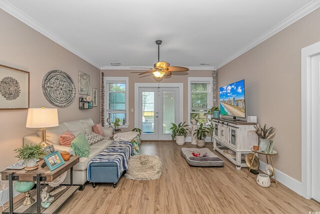 living room featuring wood finished floors, ornamental molding, ceiling fan, baseboards, and french doors