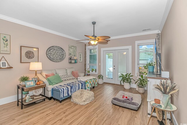 living room with french doors, wood finished floors, ornamental molding, ceiling fan, and baseboards