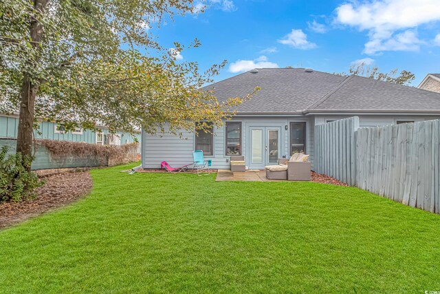back of house featuring roof with shingles and a patio area