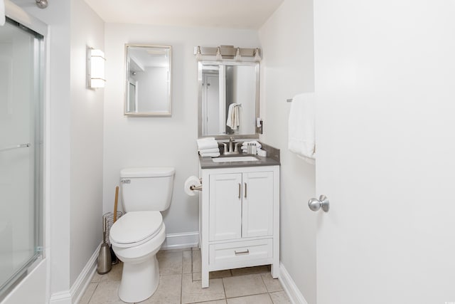bathroom featuring toilet, baseboards, tile patterned flooring, and vanity