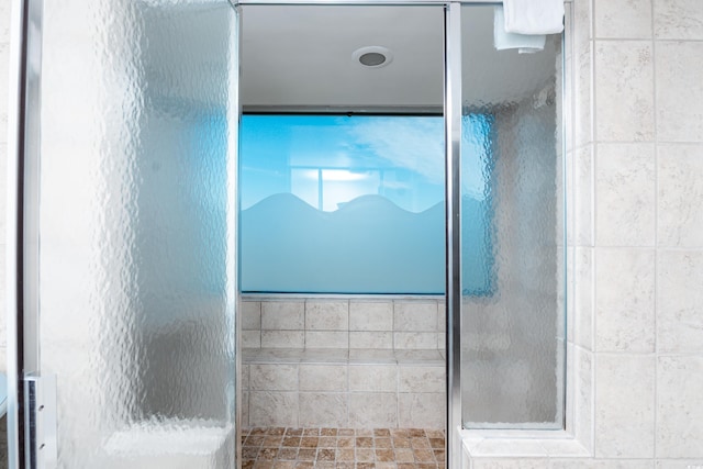 bathroom featuring a shower with door
