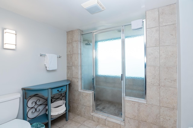 bathroom with tile patterned floors, a shower stall, toilet, and visible vents