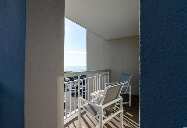 balcony with a beach view and a water view