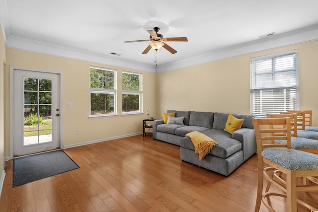 living area featuring a ceiling fan, a wealth of natural light, and visible vents
