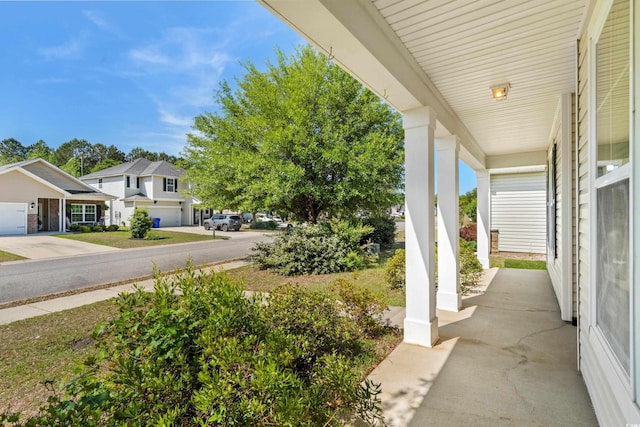 view of patio with covered porch and a residential view