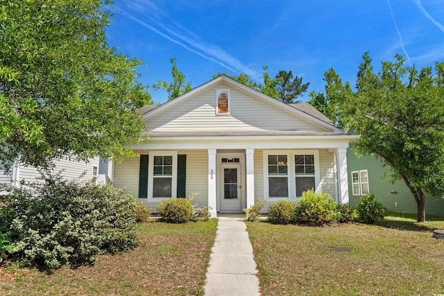 greek revival inspired property with a porch and a front lawn