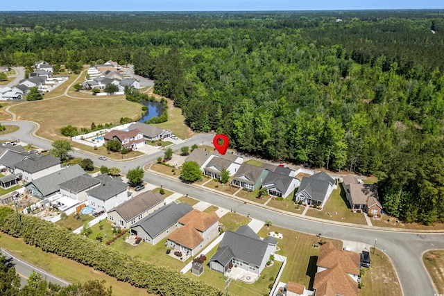 bird's eye view featuring a forest view and a residential view