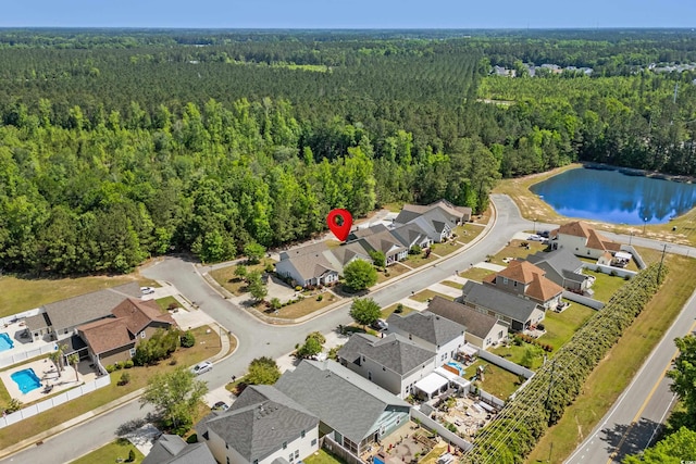 birds eye view of property with a water view, a residential view, and a wooded view