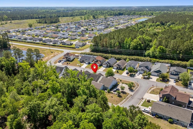 birds eye view of property featuring a wooded view and a residential view