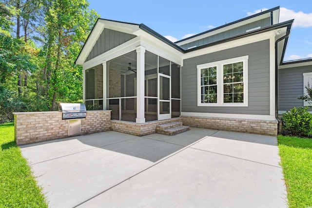 209 Bouquets Green Way, Myrtle Beach, SC 29579 - rear view of house with a sunroom, board and batten siding, an outdoor kitchen, and a patio area