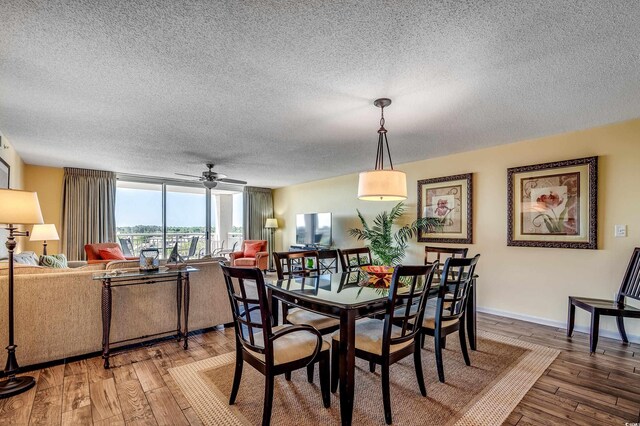 2151 Bridge View Ct Unit 2-803, North Myrtle Beach, SC 29582 - dining space featuring baseboards, a ceiling fan, a textured ceiling, and hardwood / wood-style floors