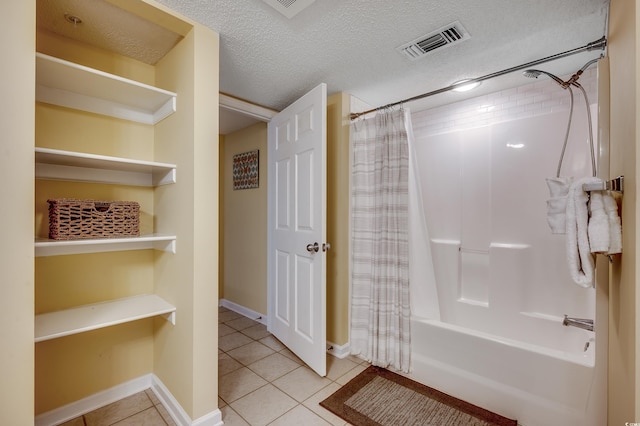 full bathroom with shower / bath combo, tile patterned flooring, a textured ceiling, baseboards, and visible vents