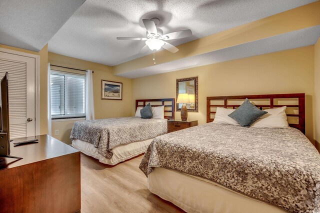 2151 Bridge View Ct Unit 2-803, North Myrtle Beach, SC 29582 - bedroom featuring a textured ceiling, ceiling fan, and wood finished floors