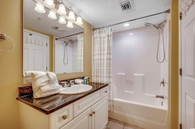 bathroom with visible vents, a textured ceiling, shower / bath combination with curtain, and vanity