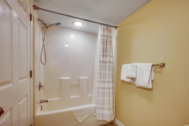 full bath featuring shower / bathtub combination with curtain and a textured ceiling