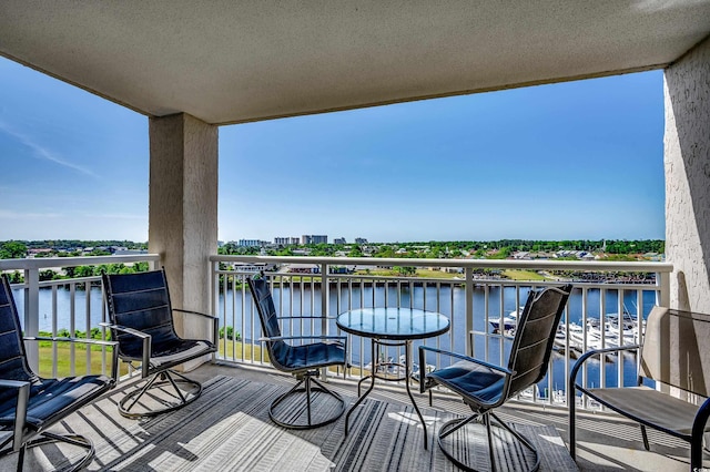 wooden deck featuring a water view