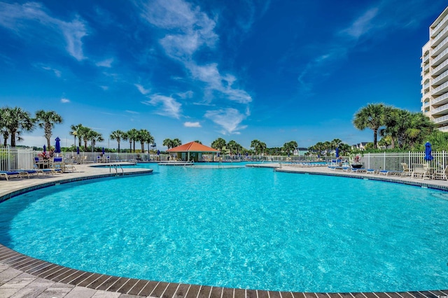 pool with fence and a patio area
