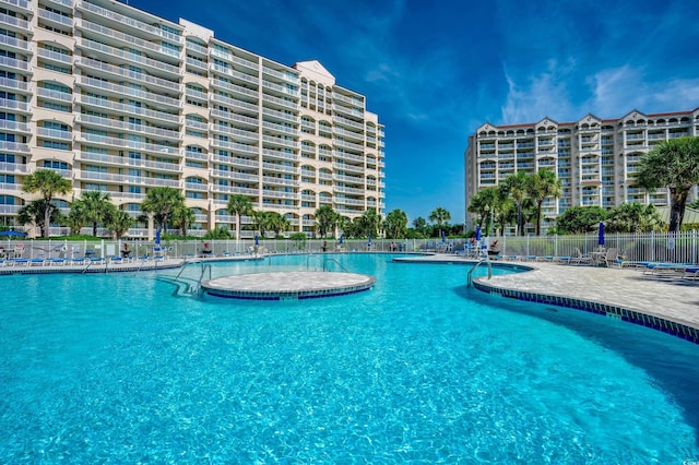community pool featuring a patio area and fence